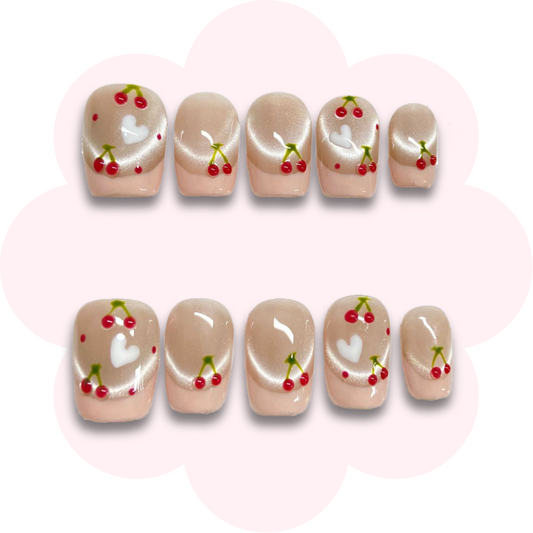 French cherry accents on nude cat eye base with nude color French tips press on nail art. long lasting and reusable