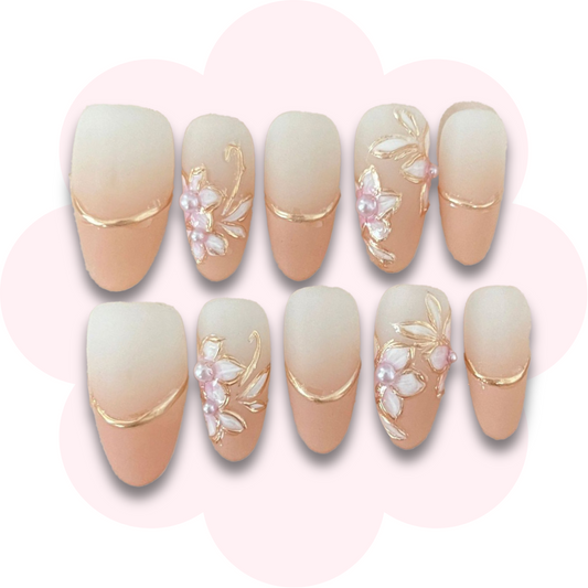 soft peach blossom nails with gold cherry blossom floral design with pearl and gold accents 