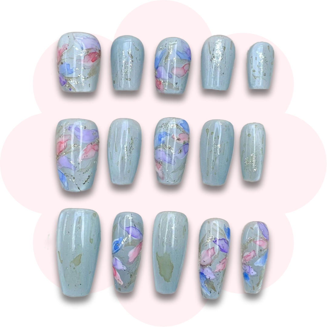 elegant press on false nails with pastel watercolour floral design on a soft sage green background, featuring delicate glitter accents in short, long coffin and almond shapes. long lasting and reusable