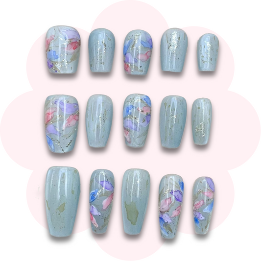 elegant press on false nails with pastel watercolour floral design on a soft sage green background, featuring delicate glitter accents in short, long coffin and almond shapes. long lasting and reusable