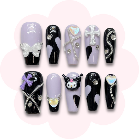 Sanrio kuromi inspired nails featuring kuromi charm on a purple base color with chain bow and rhinestone accents.