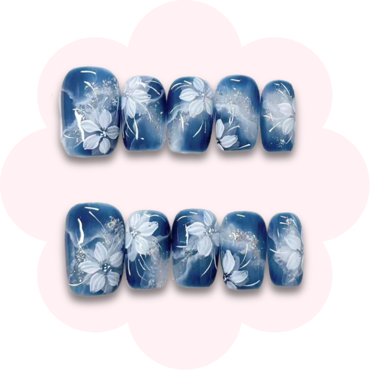 midnight bloom press on nails featuring a deep blue base with delicate white floral accents and subtle glitter details. Perfect for an elegant manicure. Easy to apply, reusable and ideal for everyday and special occasion