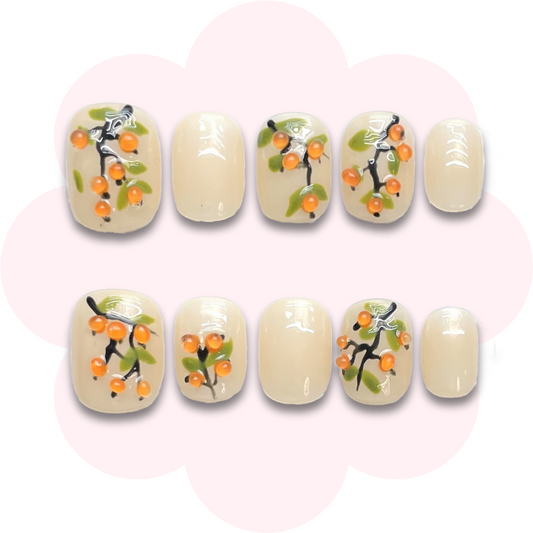 super short press on nails featuring oranges branch on a nude background. perfect for summers. easy to use, long lasting, reusable